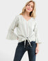 Woman wearing a striped blouse and jeans on a white background