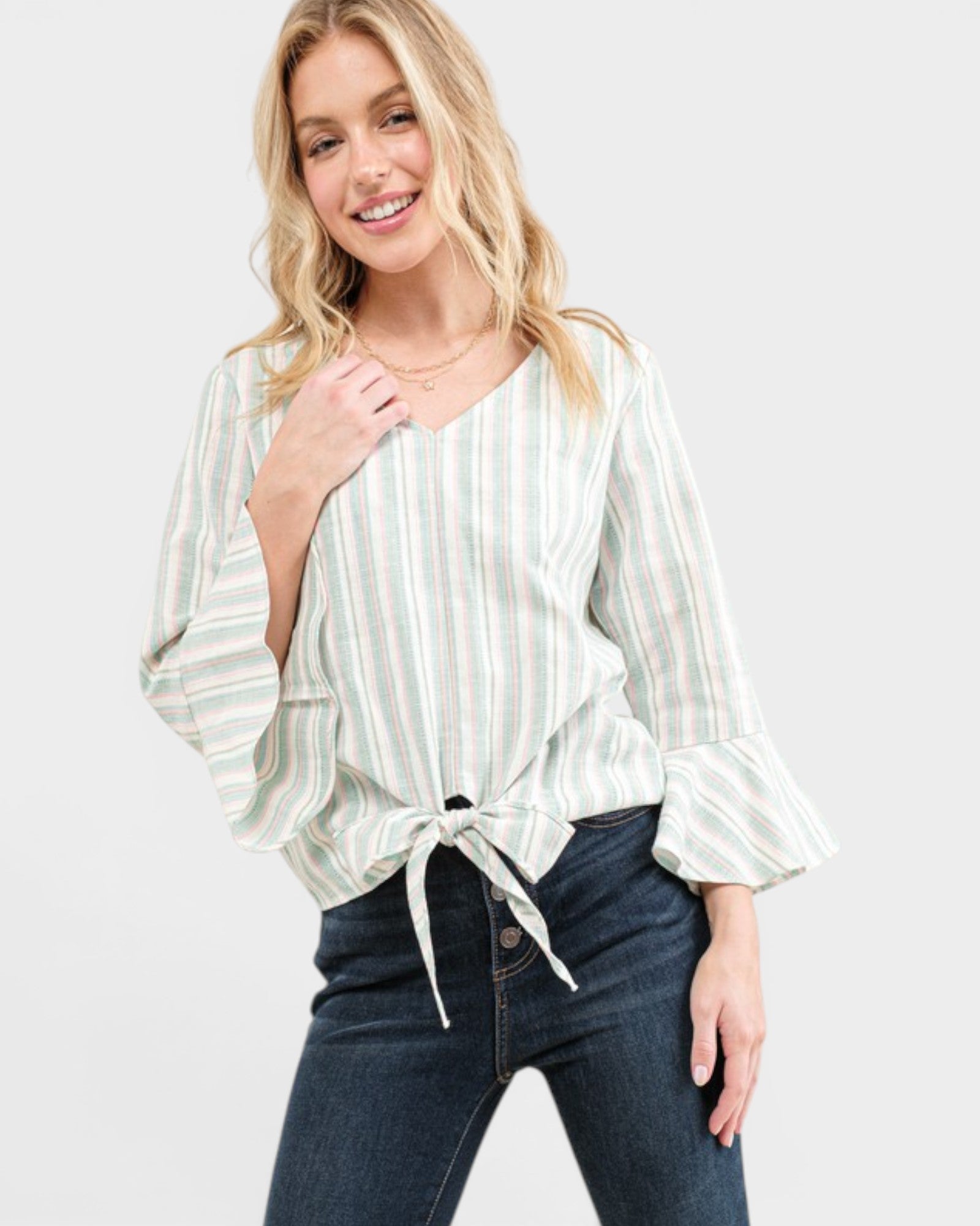 Woman wearing a striped blouse and jeans on a white background