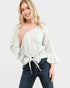 Woman wearing a striped blouse and jeans on a white background