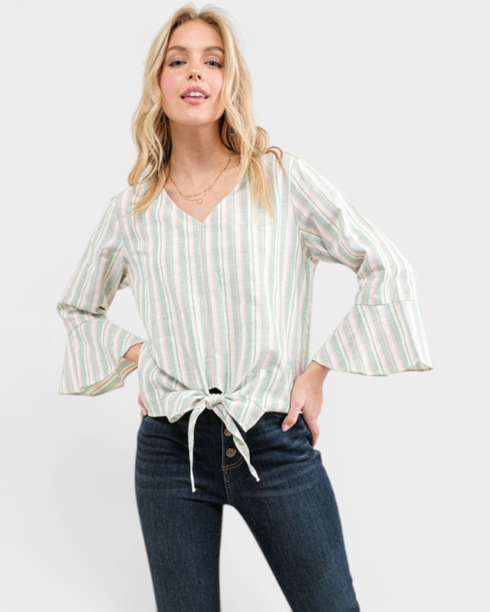 Woman wearing a striped blouse and jeans on a white background