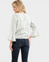 Woman wearing a striped shirt and jeans on a white background