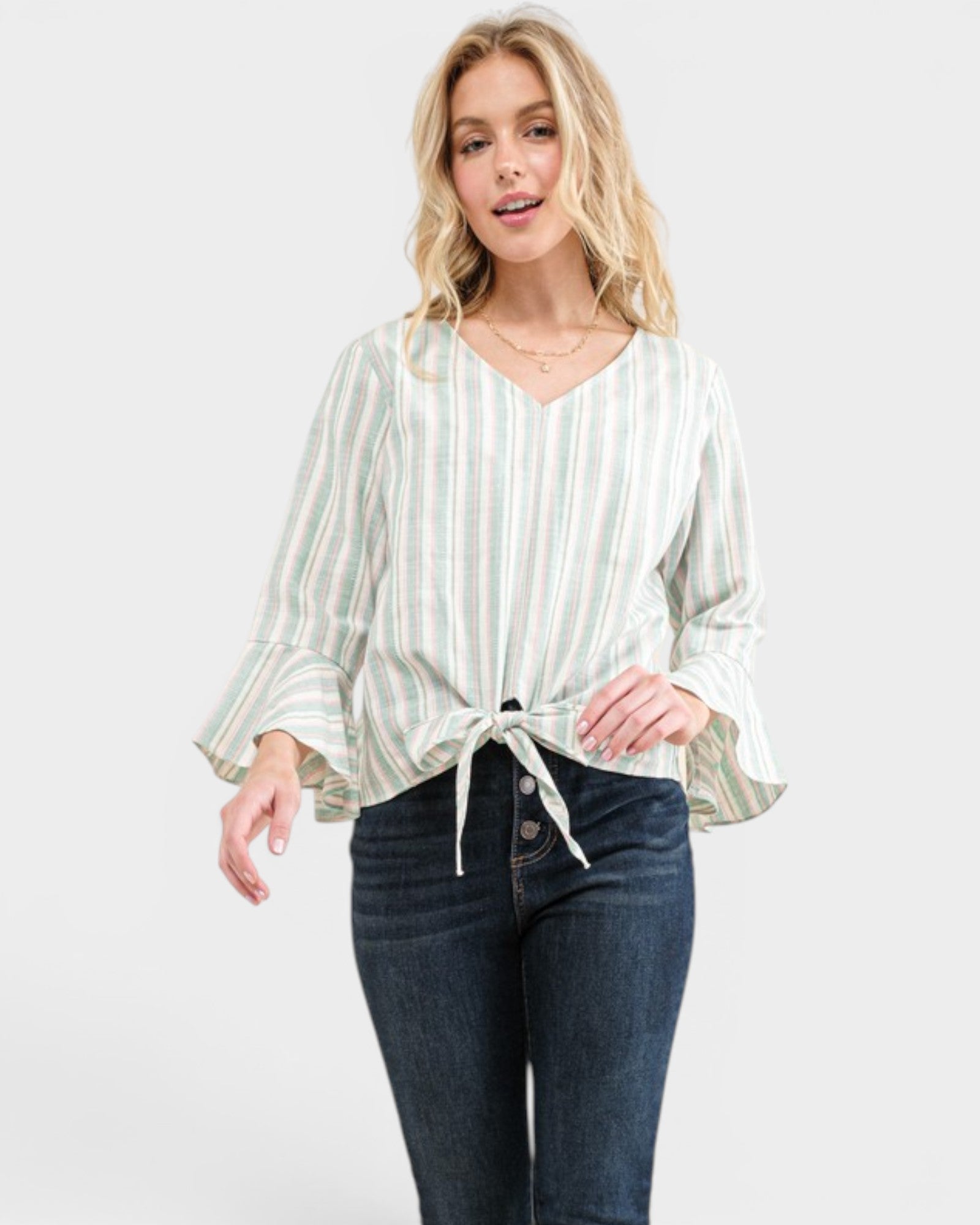 Woman wearing a striped blouse and jeans on a white background