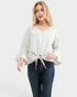 Woman wearing a striped blouse and jeans on a white background