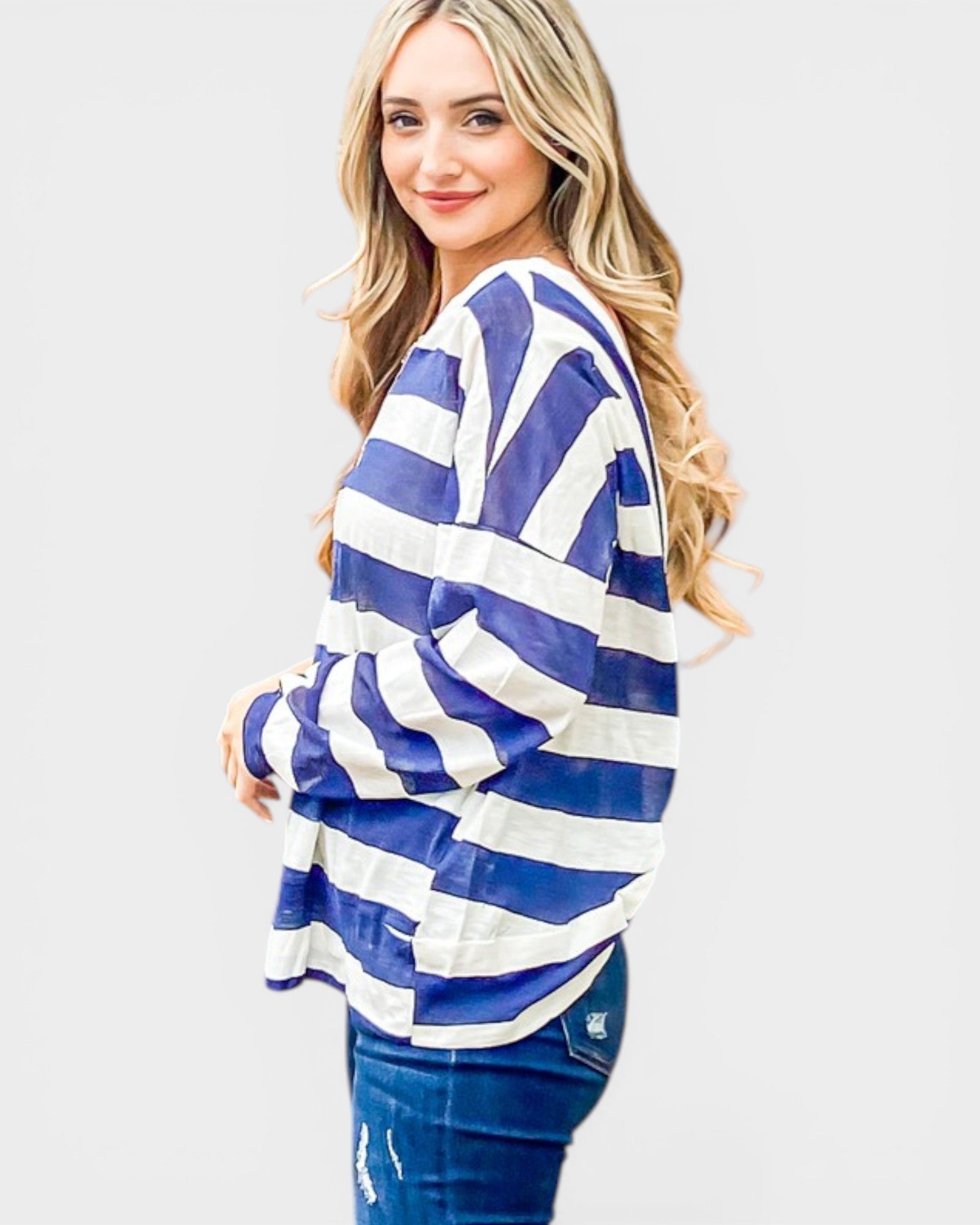 Woman wearing a blue and white striped shirt on a plain background