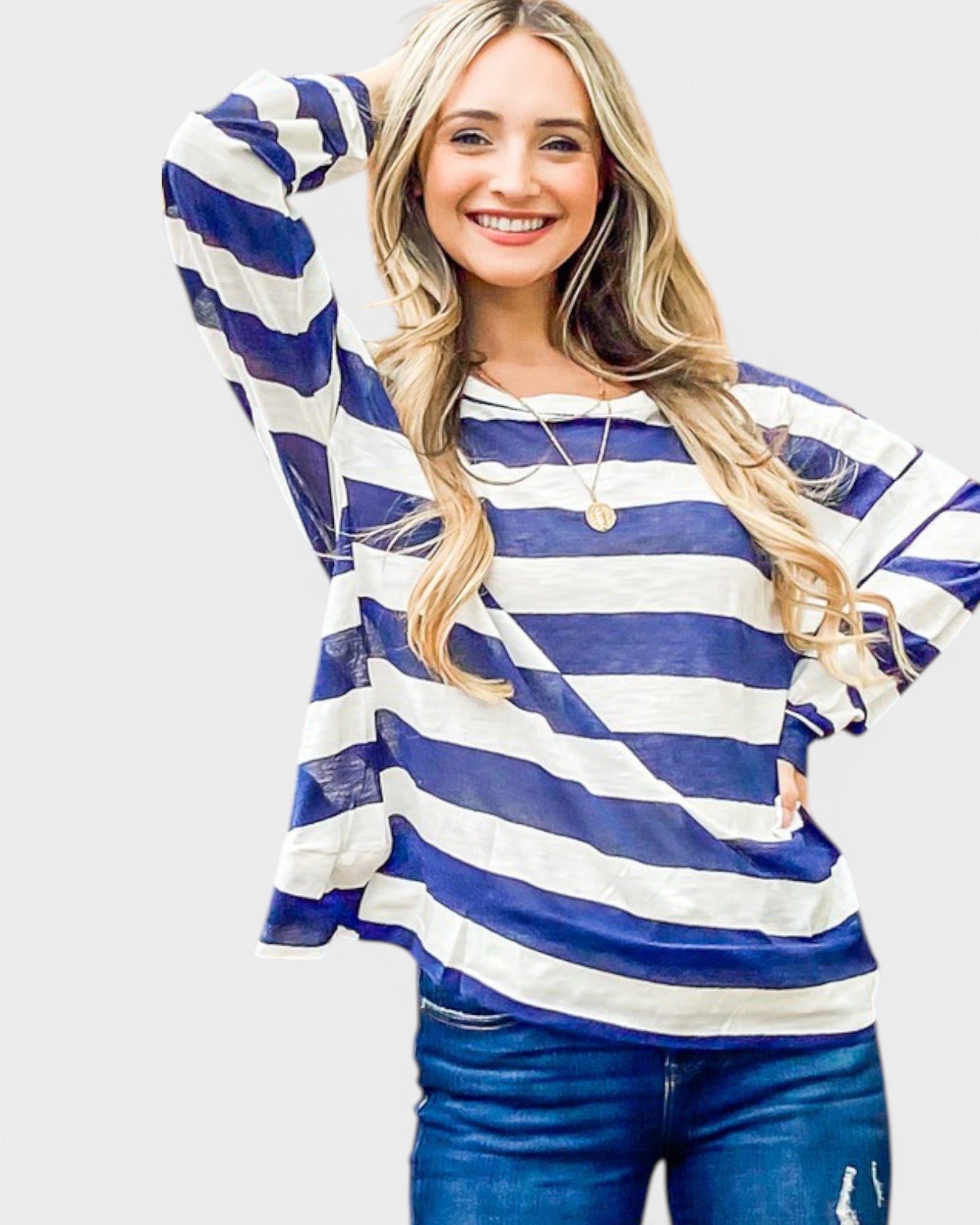 Woman wearing a blue and white striped sweater on a plain background