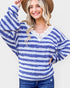 Woman wearing a blue and white striped sweater with lace details on a white background