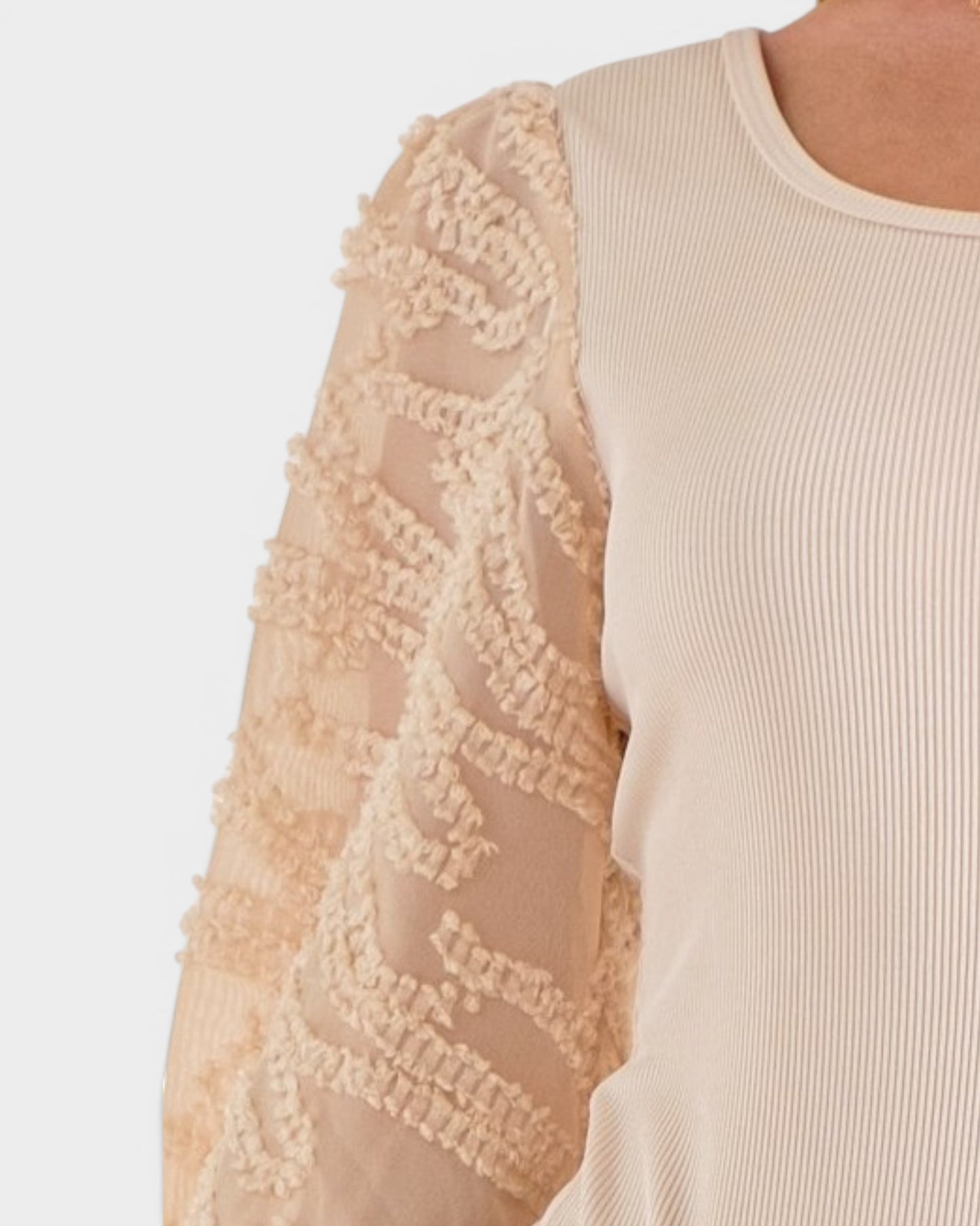 Beige sweater with lace sleeves on a light background
