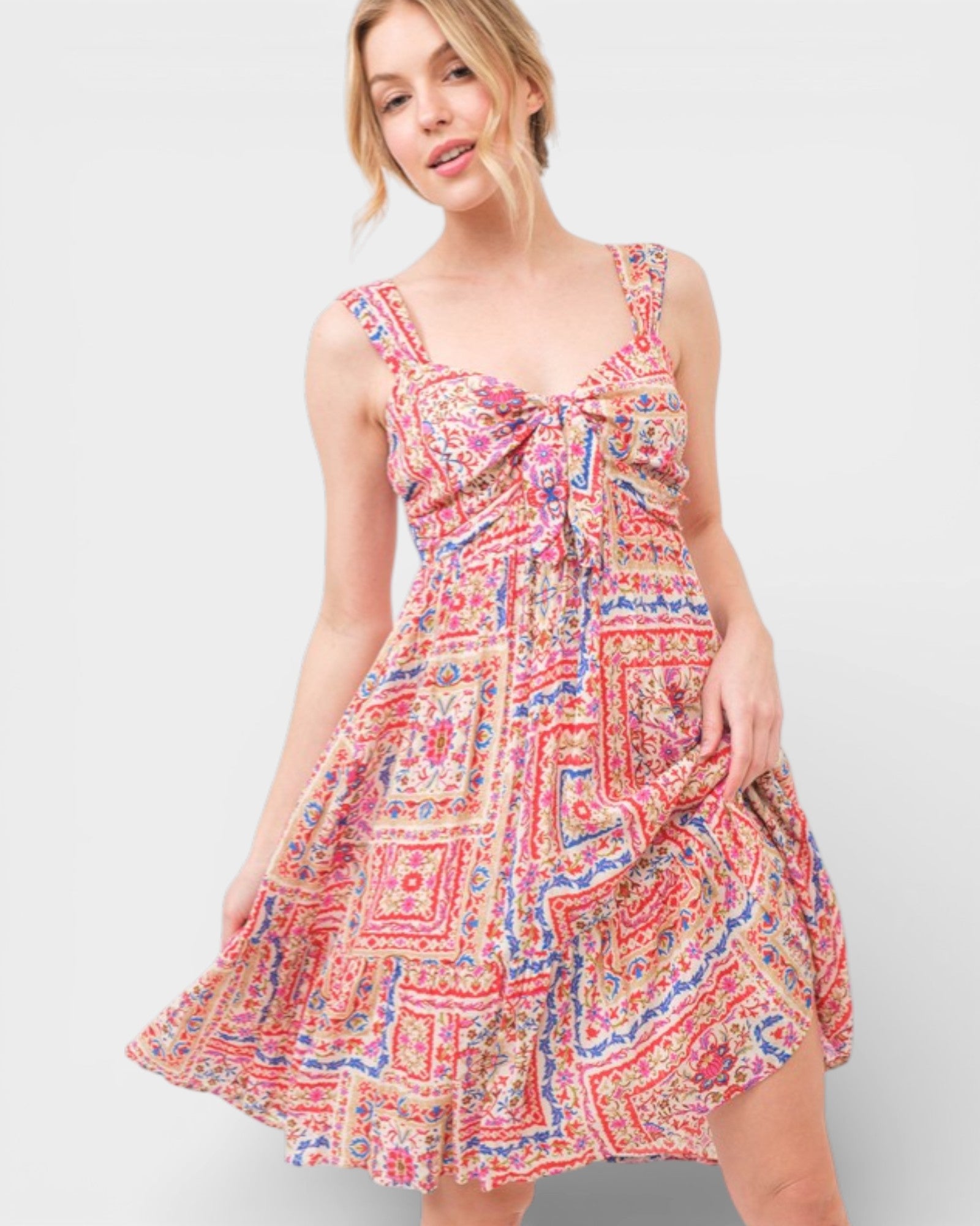 Woman wearing a colorful patterned dress on a white background