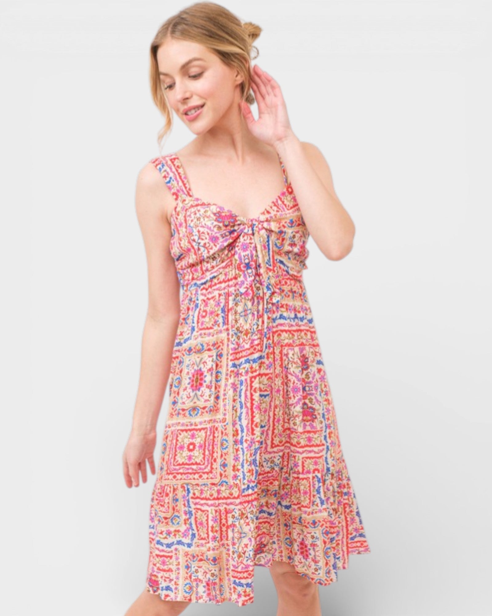 Woman wearing a colorful patterned dress on a white background