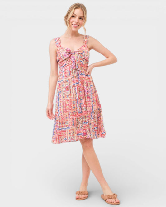 Woman wearing a colorful patterned dress on a white background