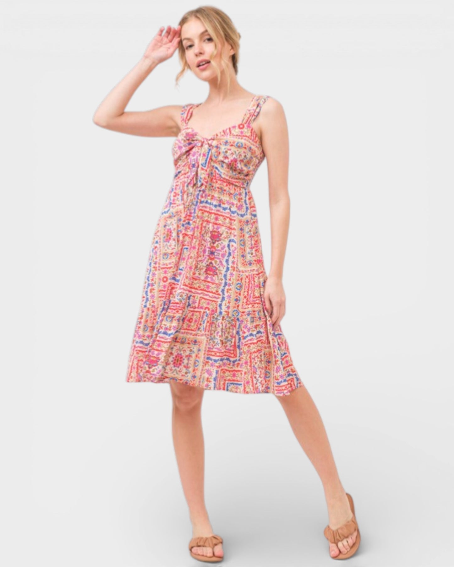 Woman wearing a colorful patterned dress on a white background