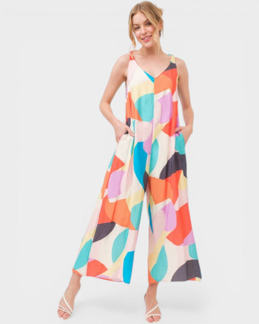 Woman wearing a colorful abstract patterned dress on a white background
