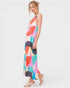 Woman wearing a colorful patterned dress on a white background