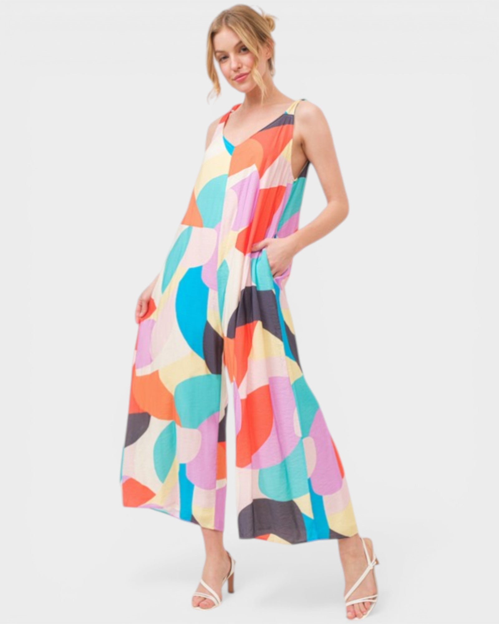 Woman wearing a colorful patterned dress on a white background