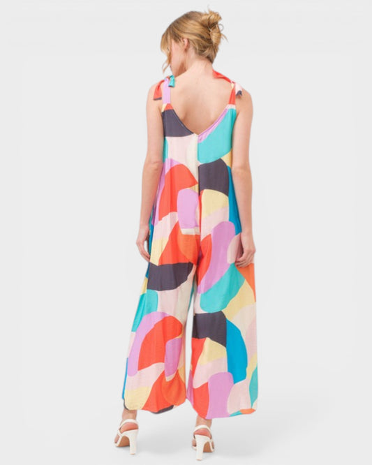 Woman wearing a colorful abstract patterned dress on a white background
