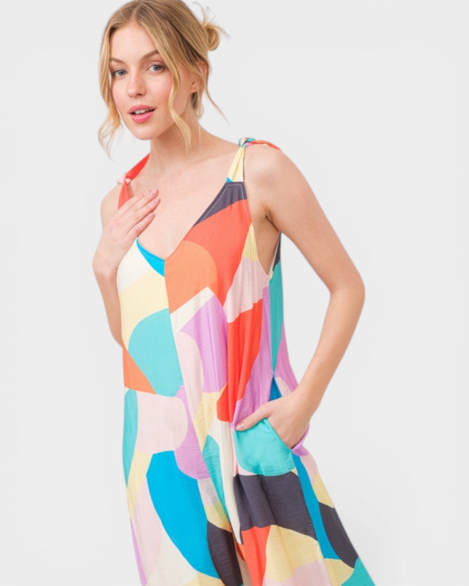 Woman wearing a colorful abstract patterned dress on a white background