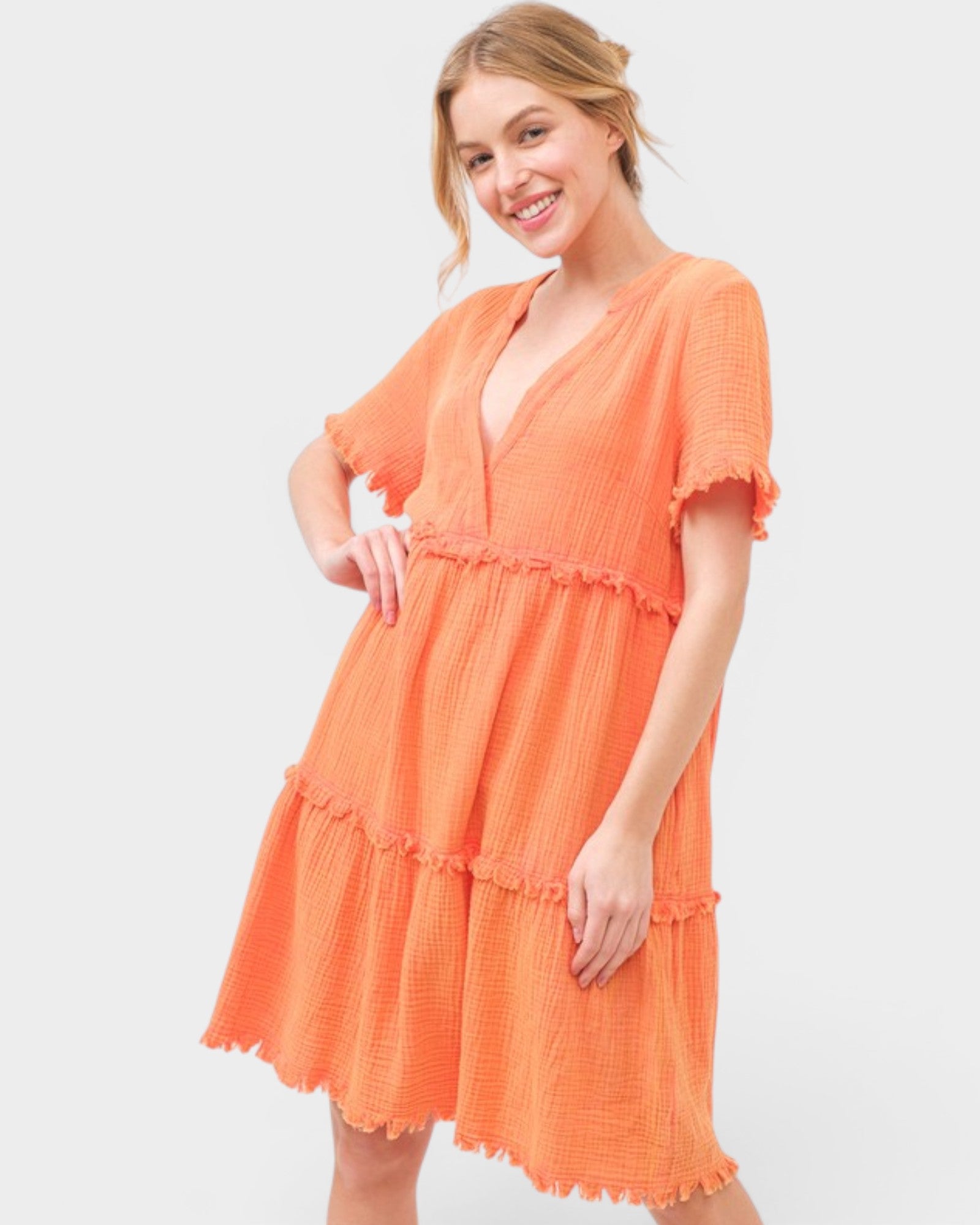 Woman wearing an orange dress on a white background