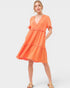 Woman wearing an orange dress on a white background