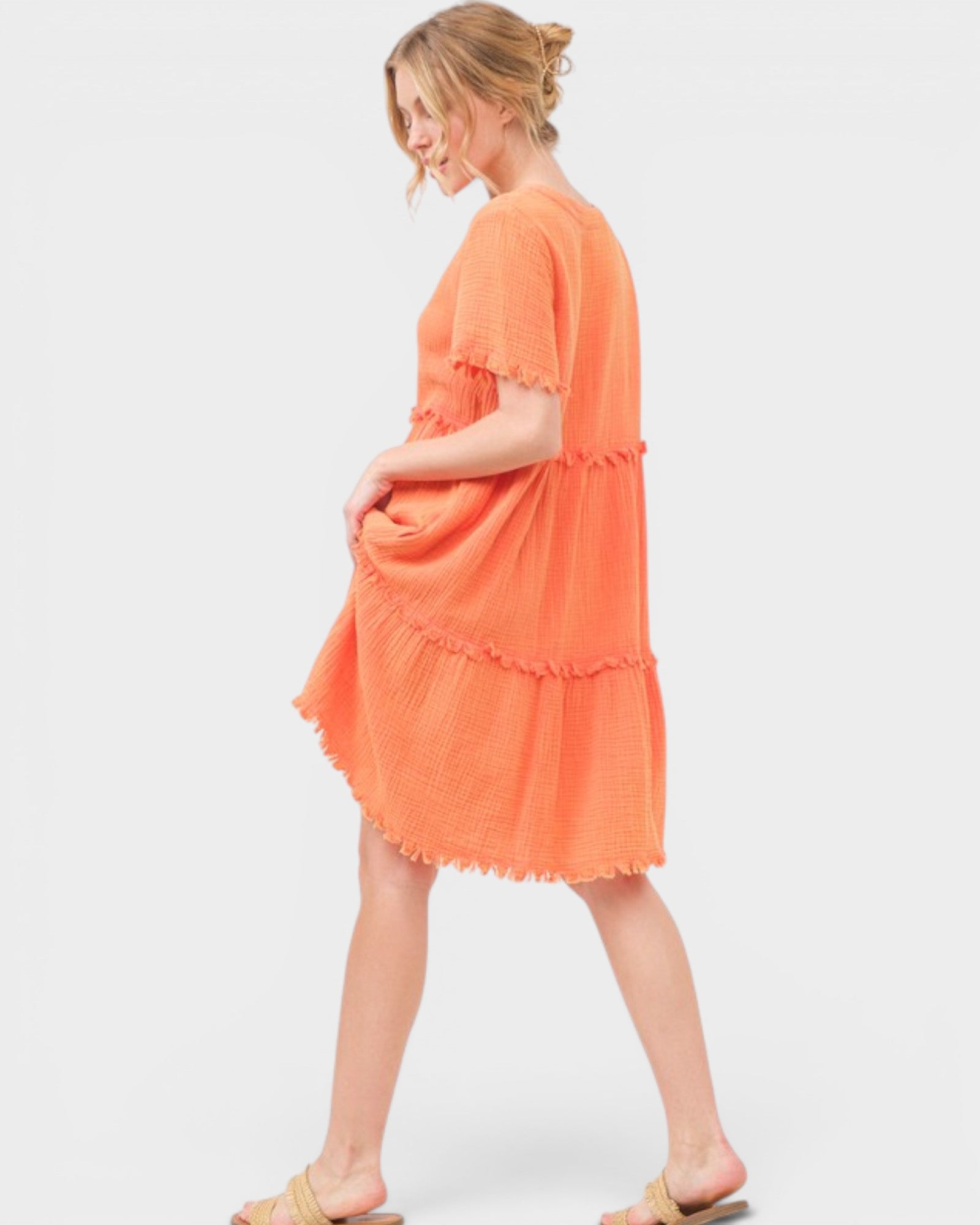 Woman wearing an orange dress on a white background