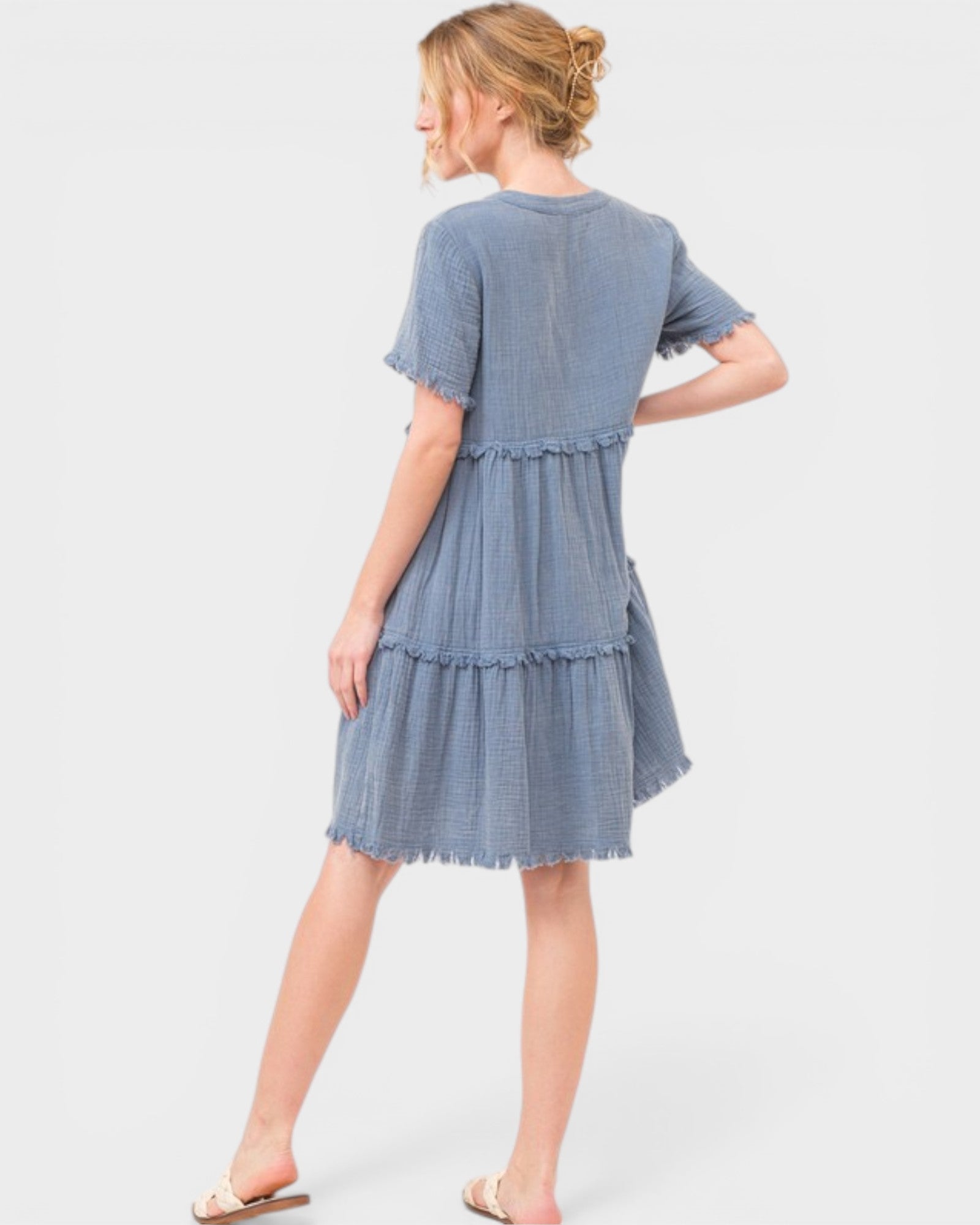 Woman wearing a blue denim dress on a white background