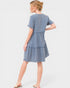 Woman wearing a blue denim dress on a white background