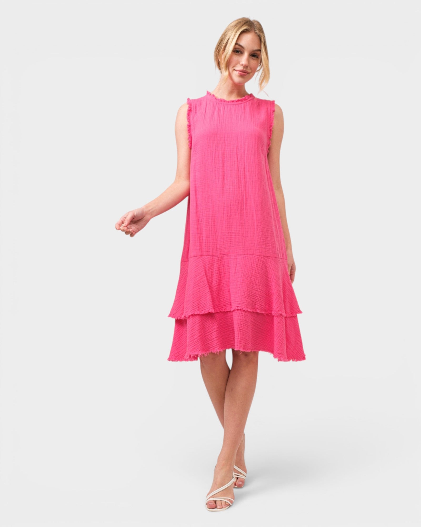 Woman wearing a pink dress on a white background