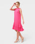 Woman wearing a pink dress on a white background