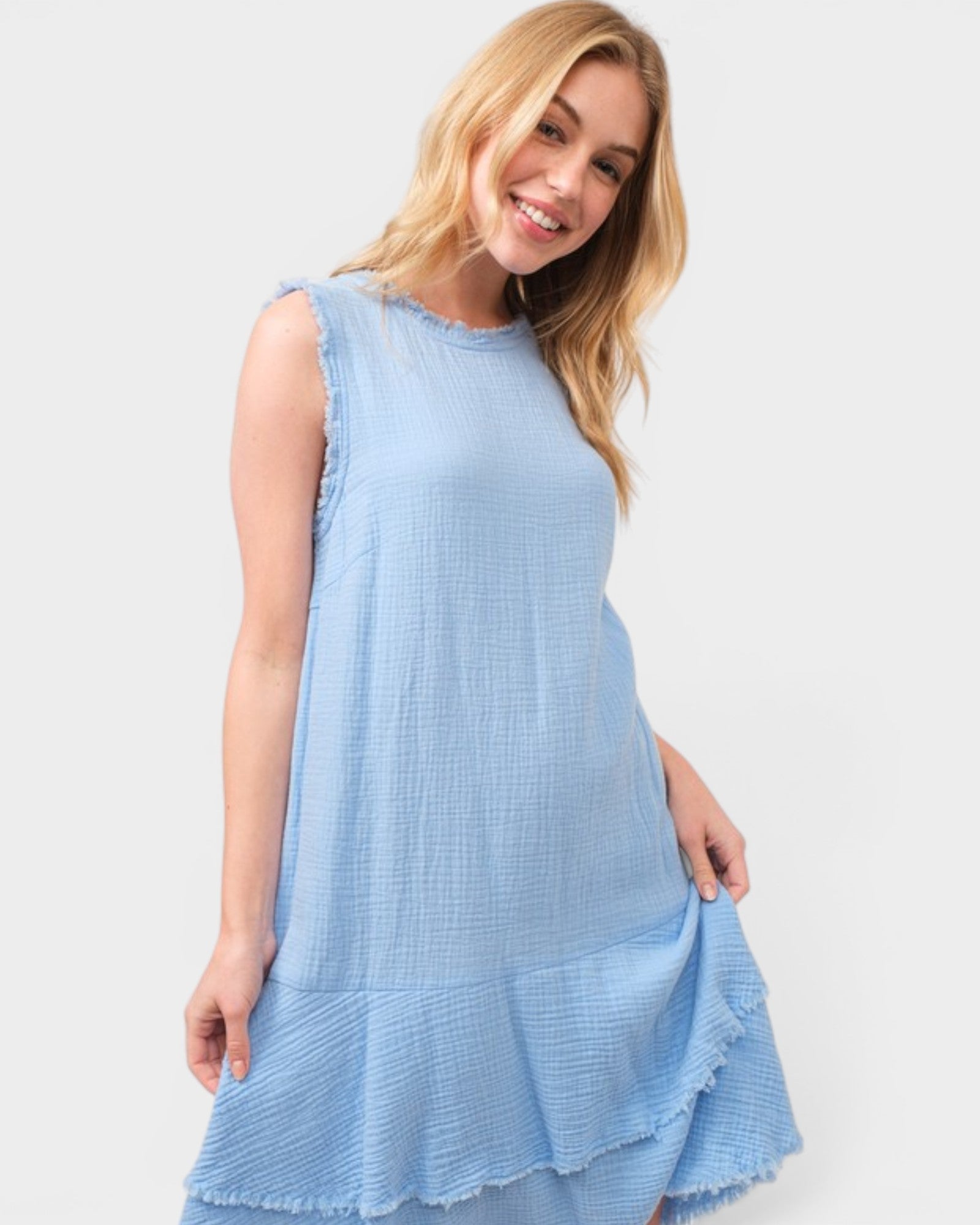 Woman wearing a light blue dress against a white background