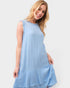 Woman wearing a light blue dress against a white background