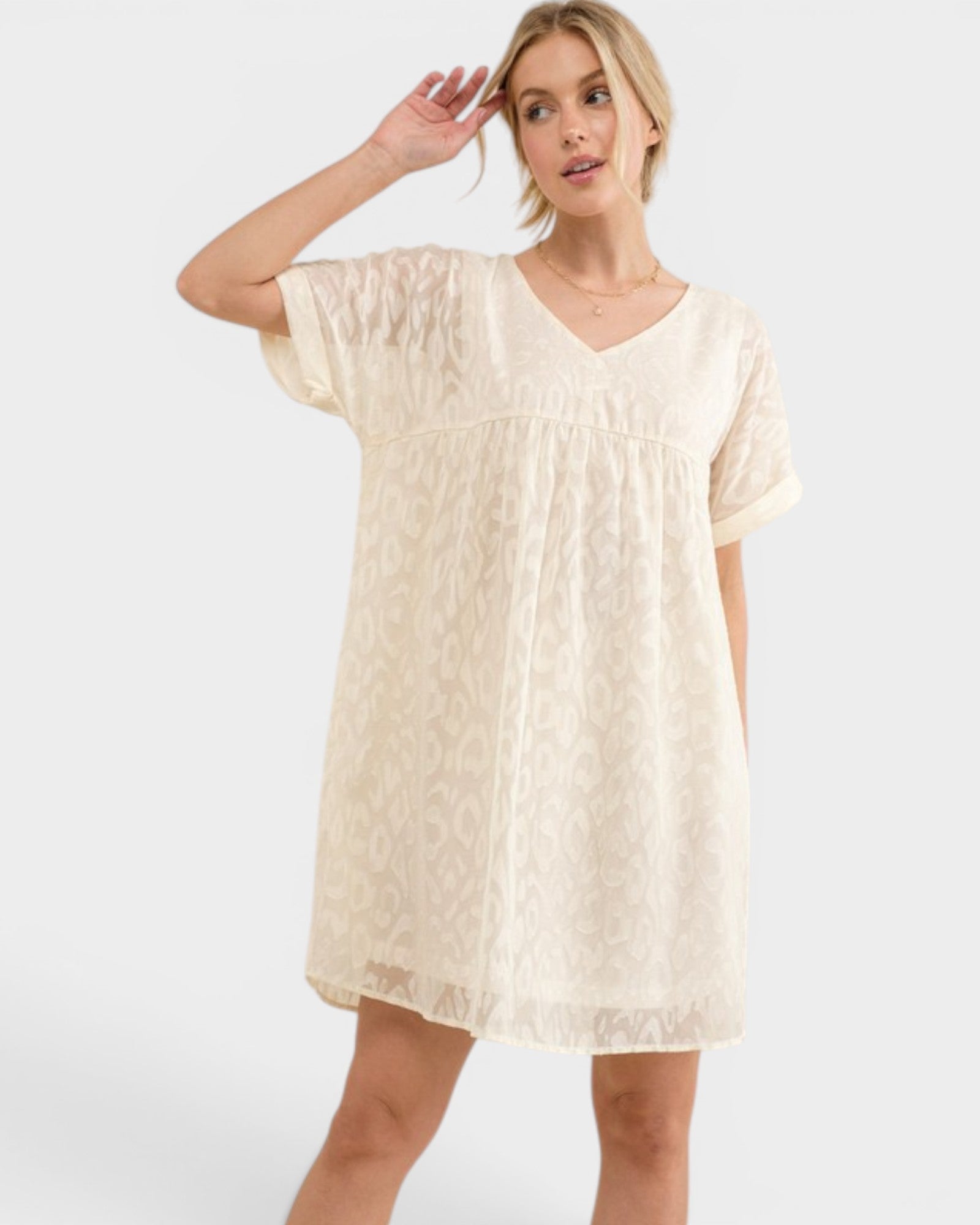 Woman wearing a beige dress on a white background