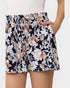 Floral shorts worn by a person on a plain background
