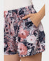 Floral patterned shorts being worn with a neutral background
