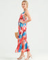 Woman wearing a colorful geometric patterned dress on a white background