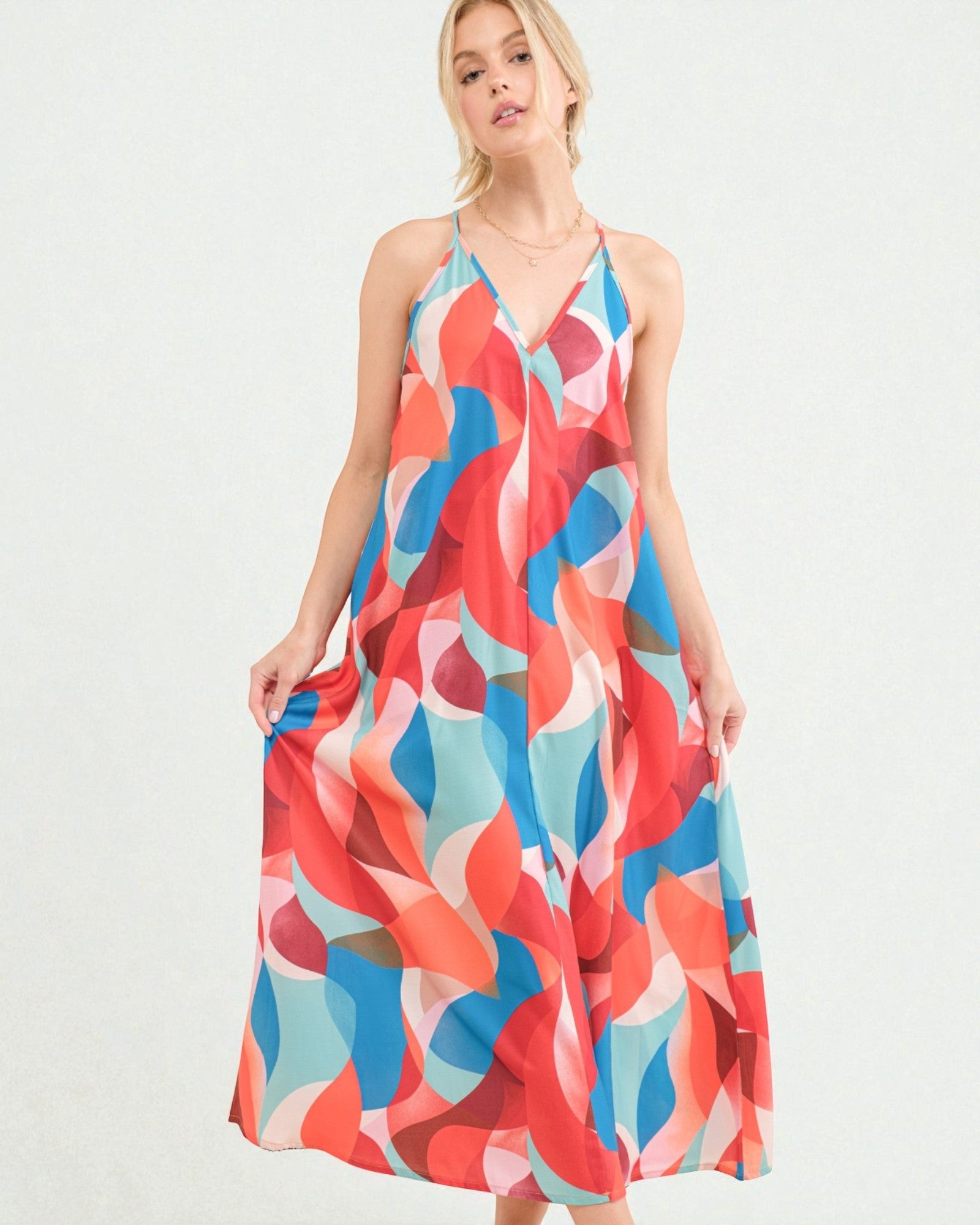 Woman wearing a colorful patterned dress on a white background