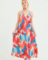 Woman wearing a colorful patterned dress on a white background