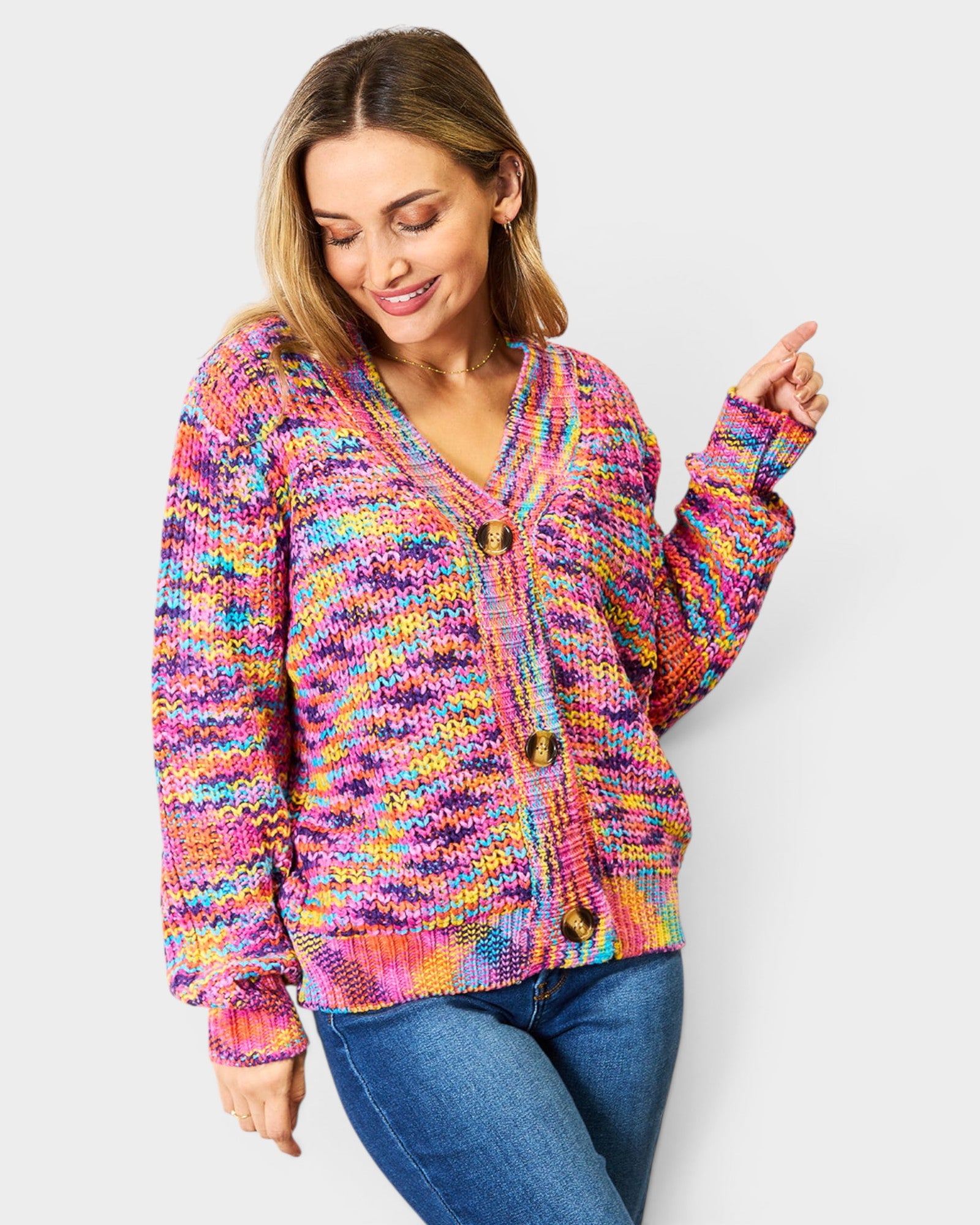 Woman wearing a colorful knitted cardigan against a white background