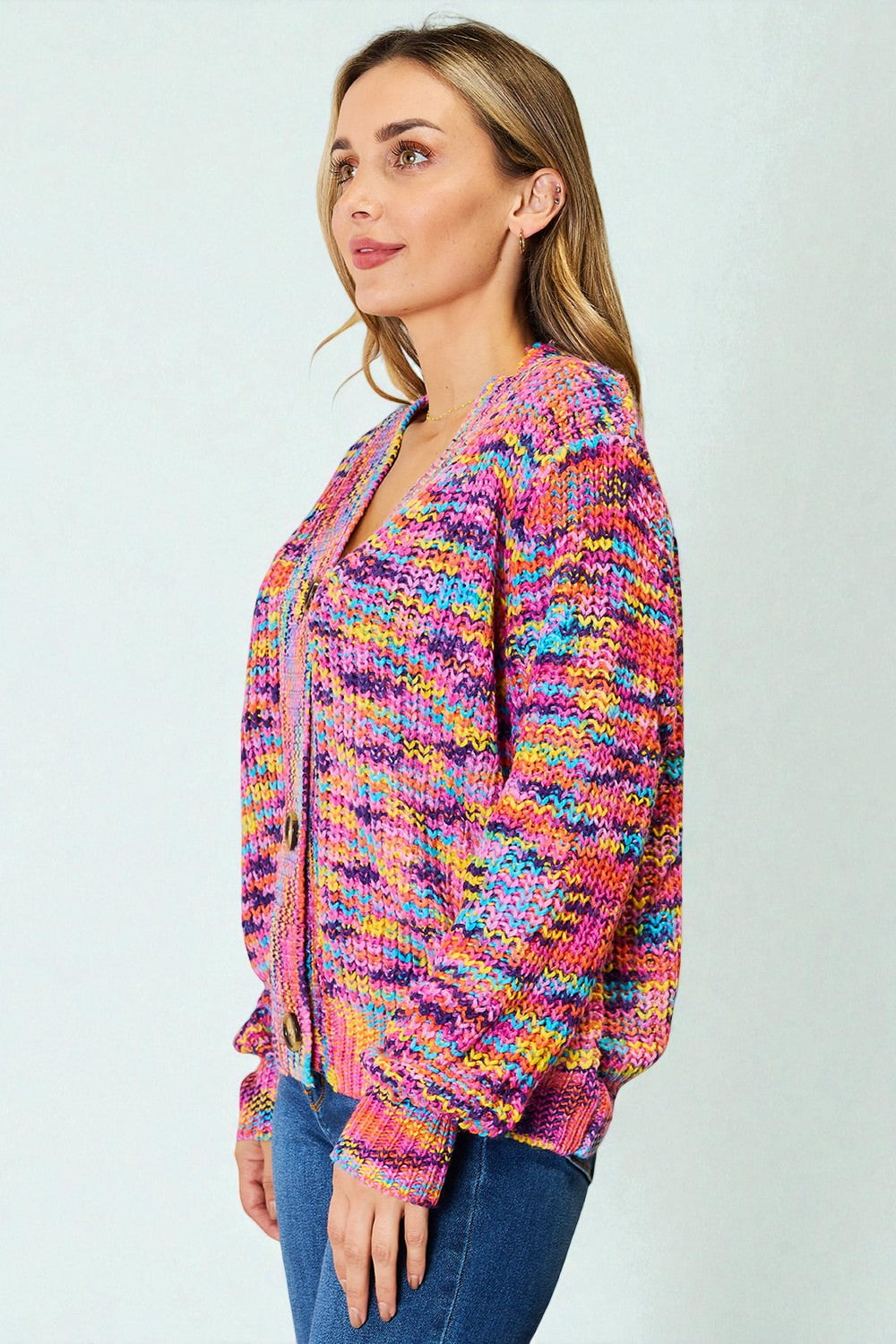 Woman wearing a colorful patterned jacket against a light gray background