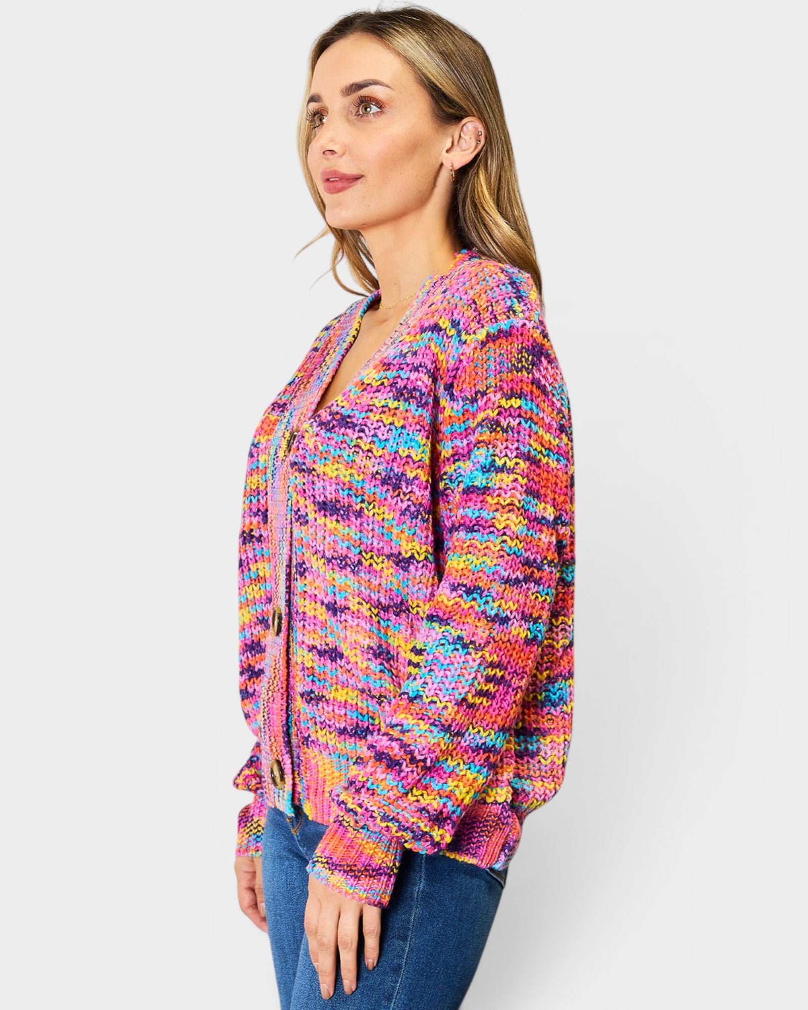 Woman wearing a colorful knitted cardigan on a white background