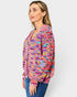 Woman wearing a colorful knitted cardigan on a white background
