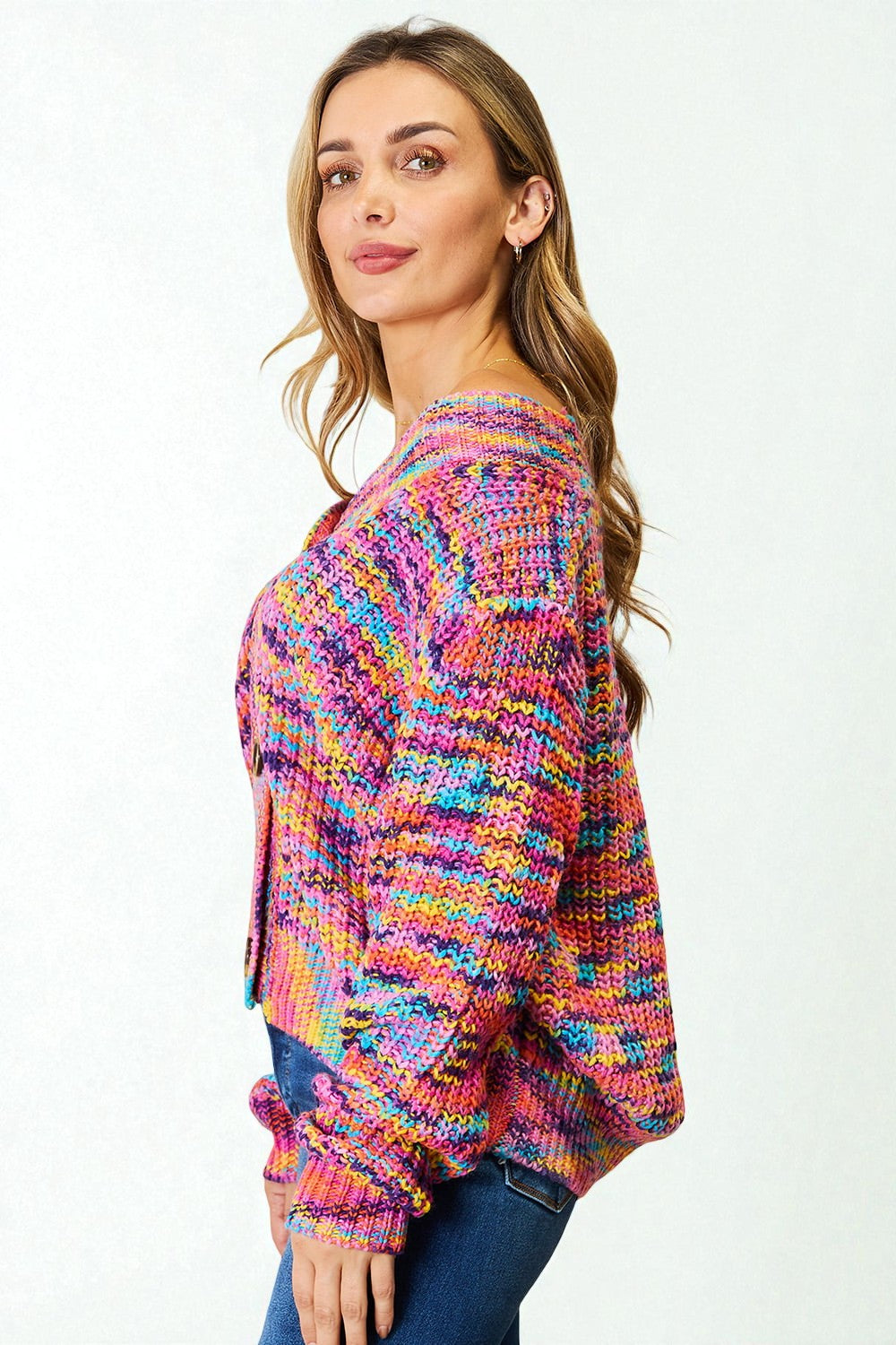 Woman wearing a colorful knitted sweater on a white background