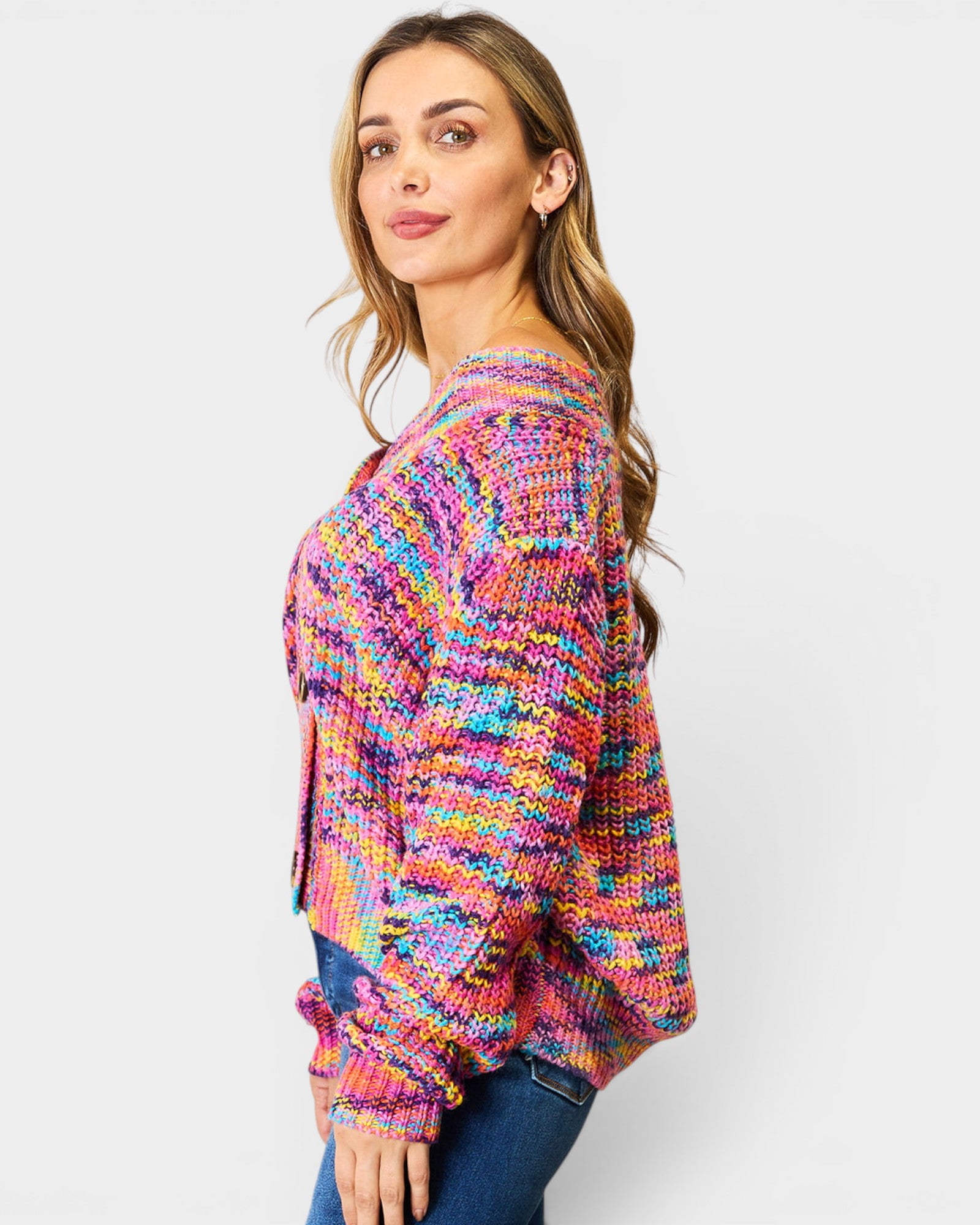 Woman wearing a colorful patterned sweater on a white background