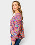 Woman wearing a colorful patterned sweater on a white background