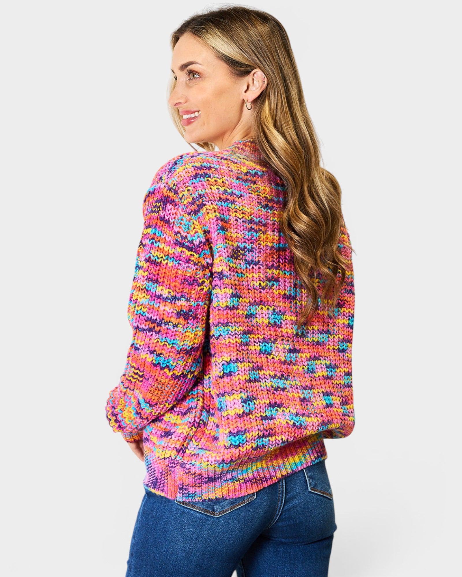 Woman wearing a colorful patterned sweater on a white background
