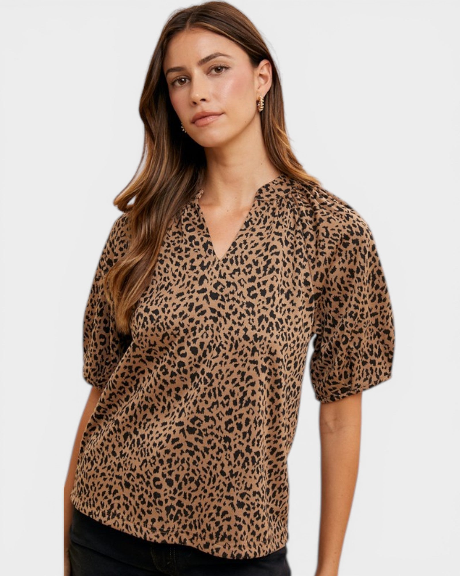 Woman wearing a leopard print blouse against a white background
