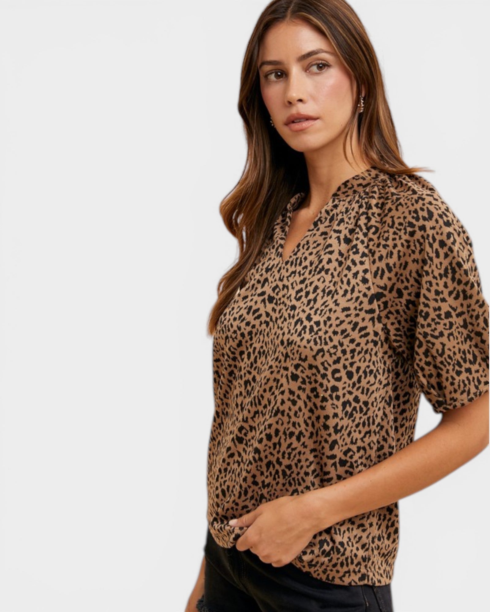 Woman wearing a leopard print blouse against a white background