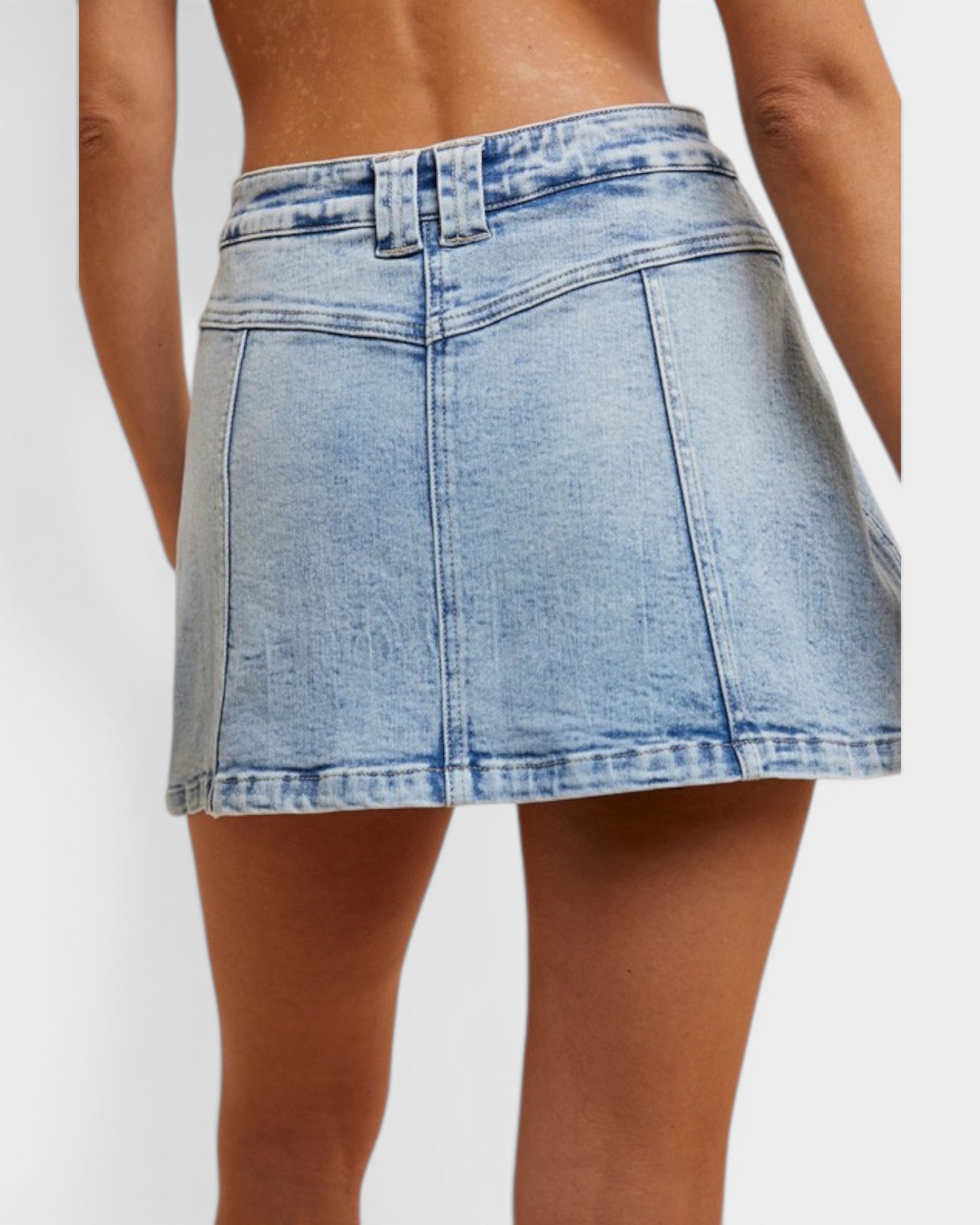 Light blue denim skirt worn by a person on a white background