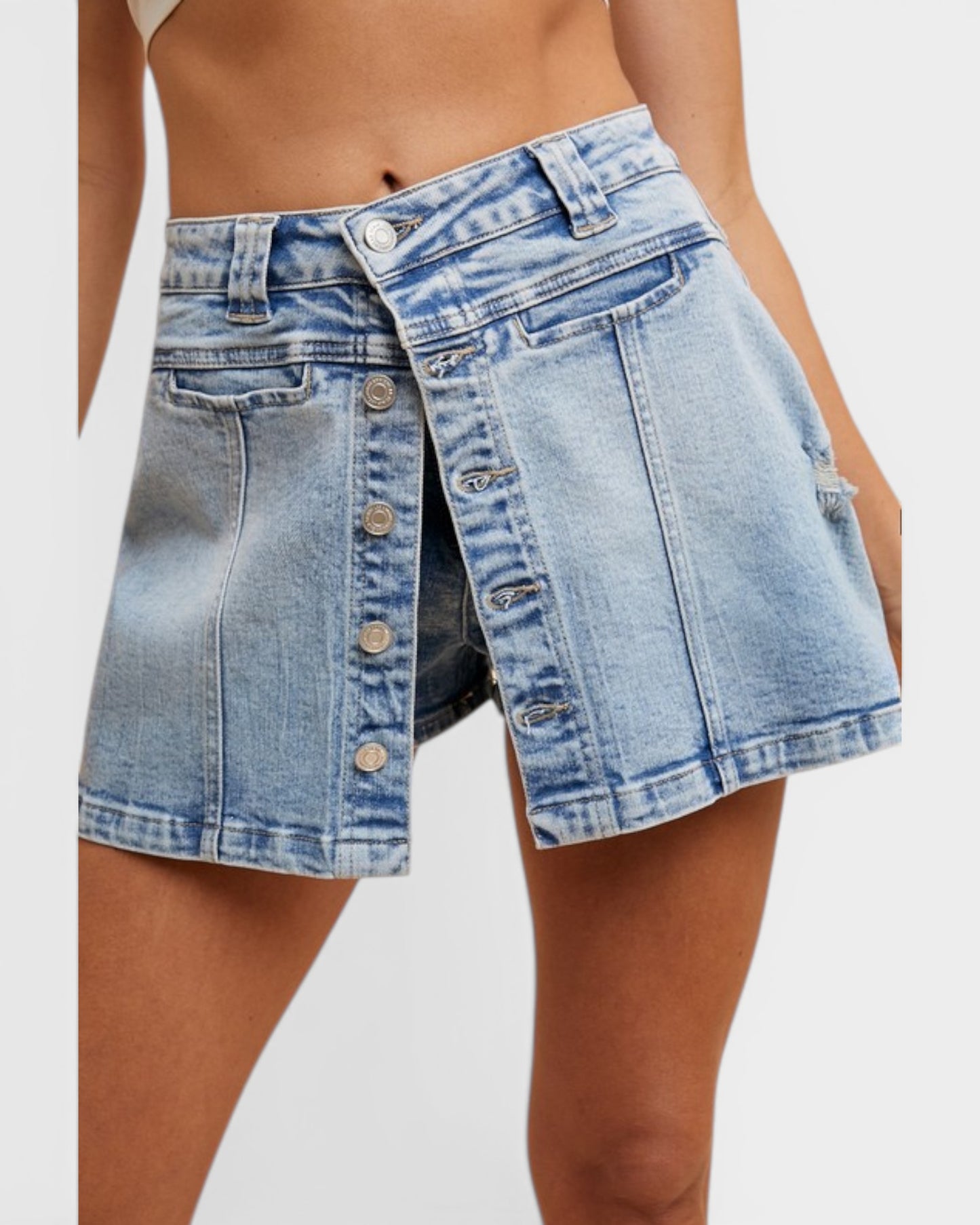 Denim skirt worn by a person on a white background