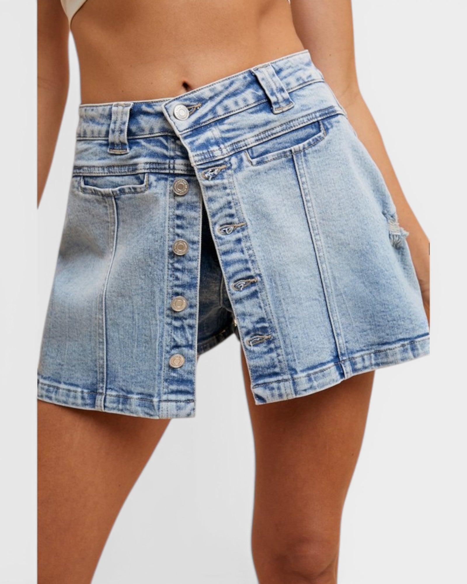 Denim skirt worn by a person on a white background