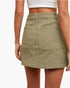 A model wearing an olive green high-waisted mini skirt with cargo pockets, shown from the back against a plain white background.