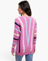 A woman shown from the back wearing a pink ribbed knit sweater with vertical stripes in cream, light blue, and black, paired with blue jeans against a plain white background.